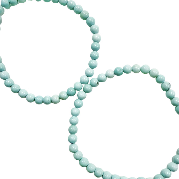 Two light blue howlite 4mm beaded necklaces on a white background