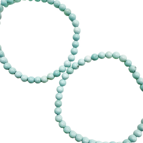 Two light blue howlite 4mm beaded necklaces on a white background