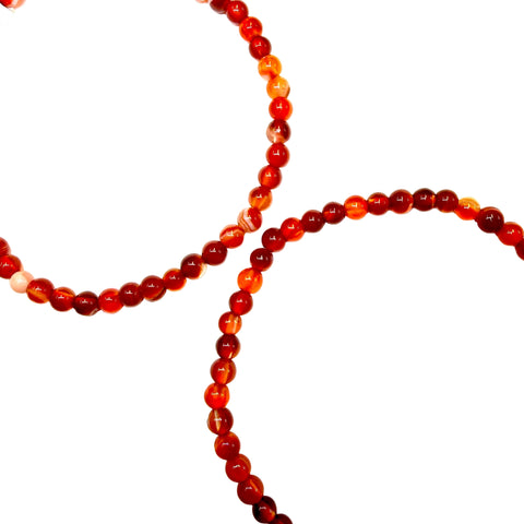 2 Carnelian beaded bracelets on a white background