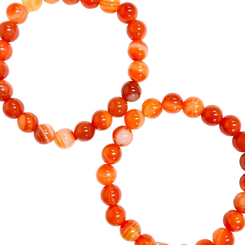 Two strands of carnelian bead bracelets with varying shades of orange and red, displayed against a white background.