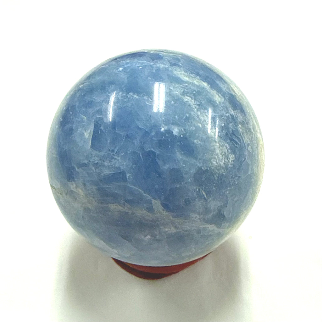 Celestite crystal sphere 5cm on a white background