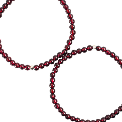 A close-up image of a garnet bracelet with 4mm beads, showcasing the texture and color of the gemstone.
