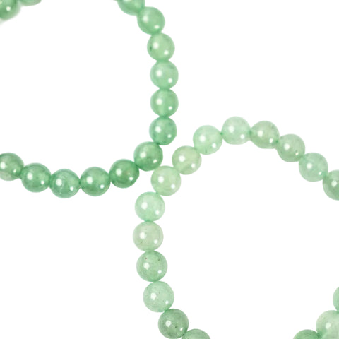 A close-up image of a green aventurine bracelet with smooth, round beads.