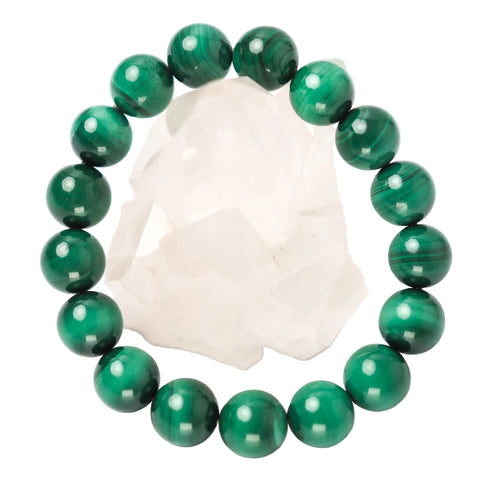 A green Malachite bracelet with bead sizes approximately 12mm, displayed on a white crystal.