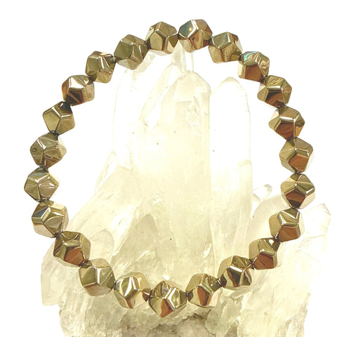Gold beaded bracelet Pyrite Dodecahedron beads on a crystal background