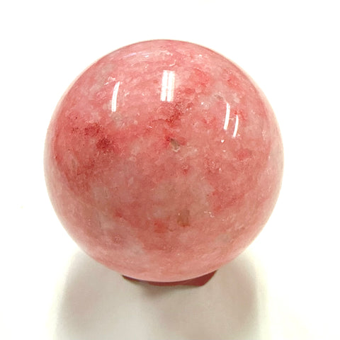 Rhodonite crystal sphere 5cm on a white background