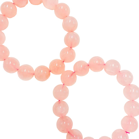 round pink rose quartz beads strung together to form a bracelet with elastic stretching cord.
