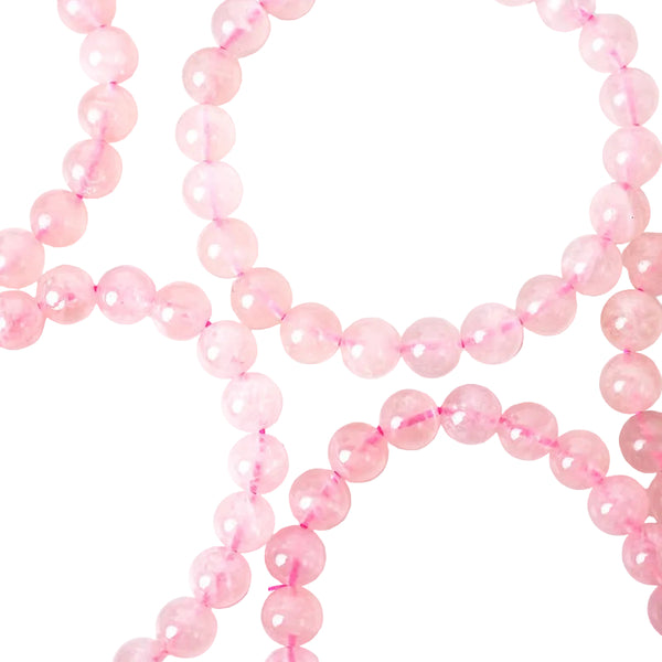 A close-up image of a rose quartz bracelet with pink beads and an elastic stretching cord.
