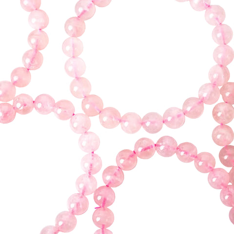 A close-up image of a rose quartz bracelet with pink beads and an elastic stretching cord.