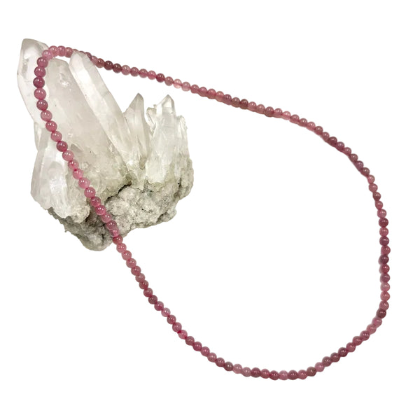 Long Necklace with pink rose quartz beads on a white background