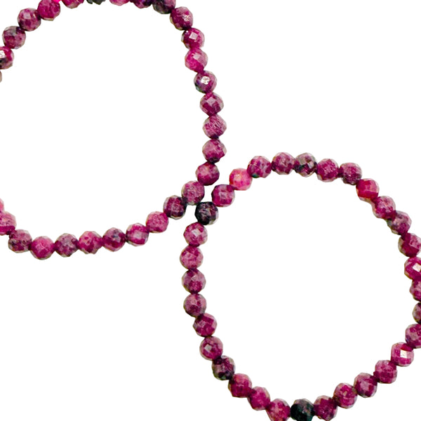 2 Ruby bracelets with faceted beads on white background