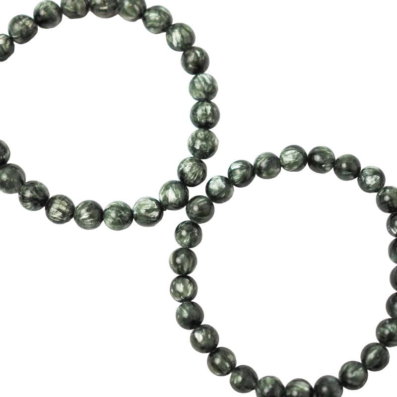 A bracelet made of dark green Seraphinite (Green Charoite) gemstones with a smooth, polished finish.
