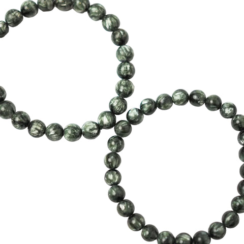 A bracelet made of dark green Seraphinite (Green Charoite) gemstones with a smooth, polished finish.