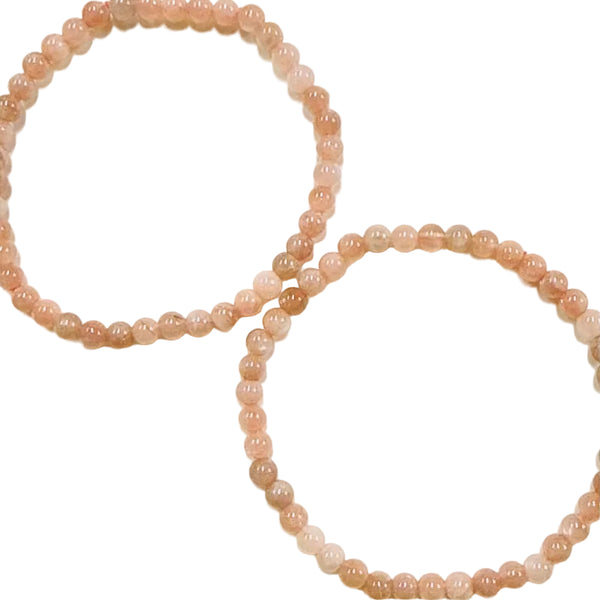 Two sunstone beaded bracelets on a light background